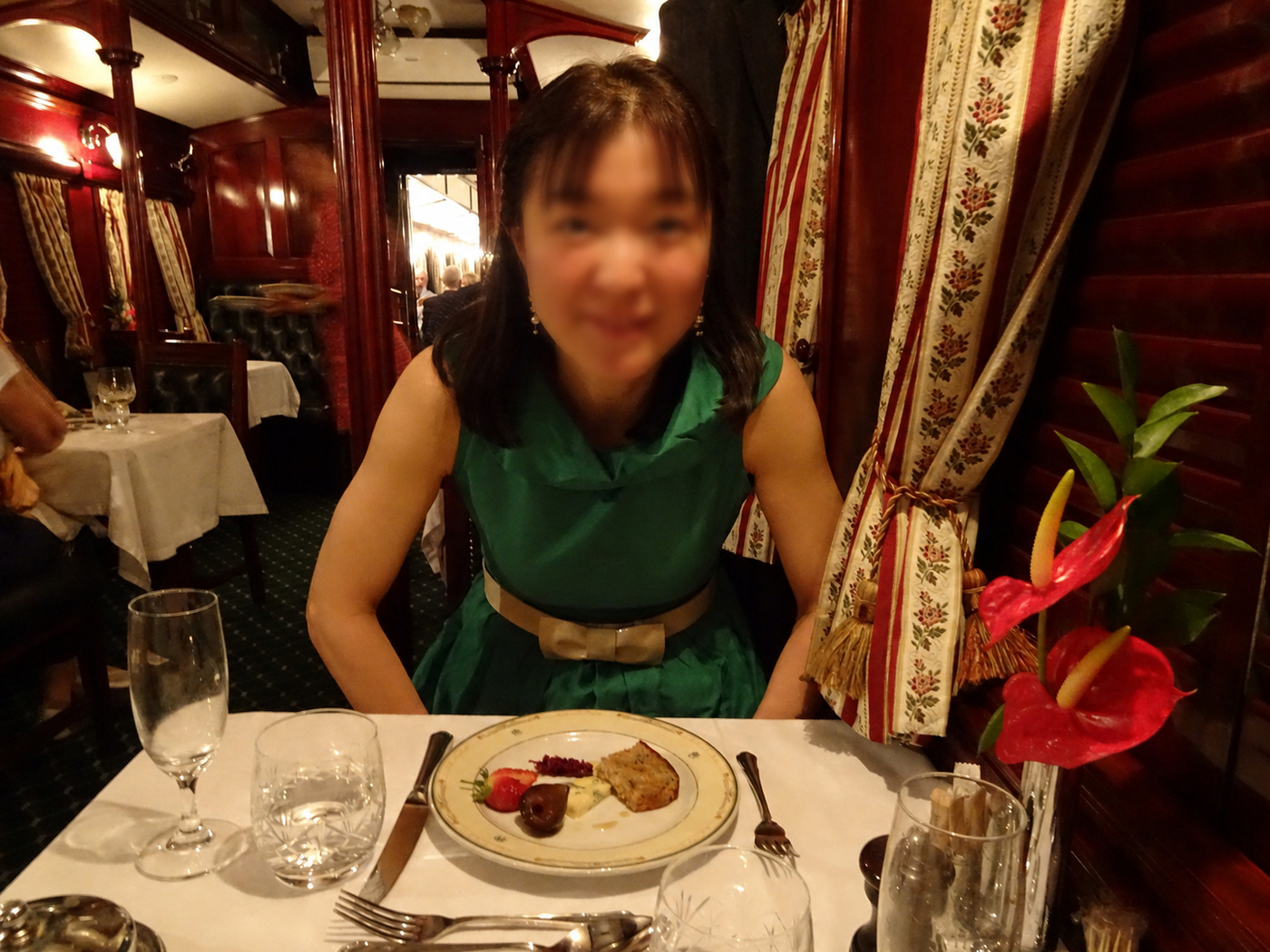 グリーンのワンピースでチーズプレートを前にする